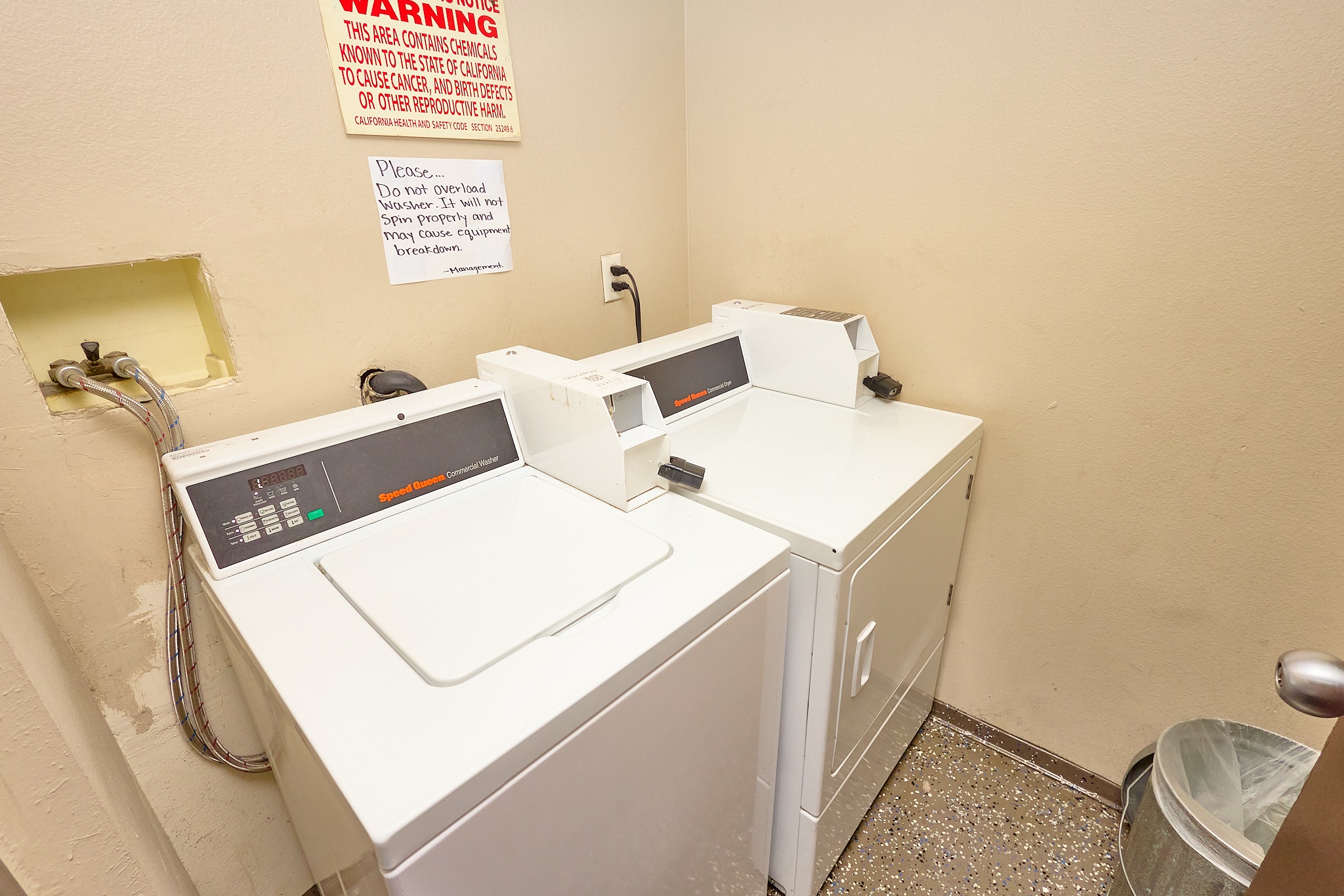 A washing machine and dryer in a small room.